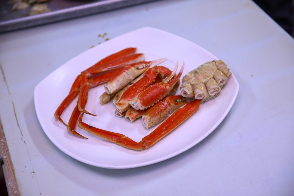 Weighing a snow crab on the scale just before cleaning